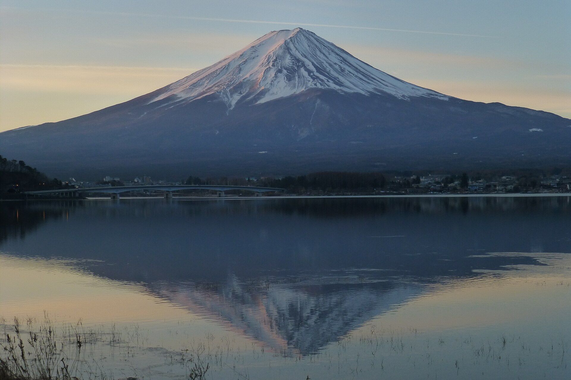 Mount Fuji reflected in the still water of Lake Kawaguchi at first light